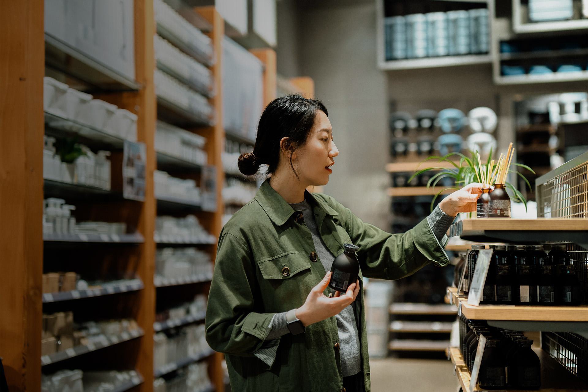 woman selecting an item from a shelf